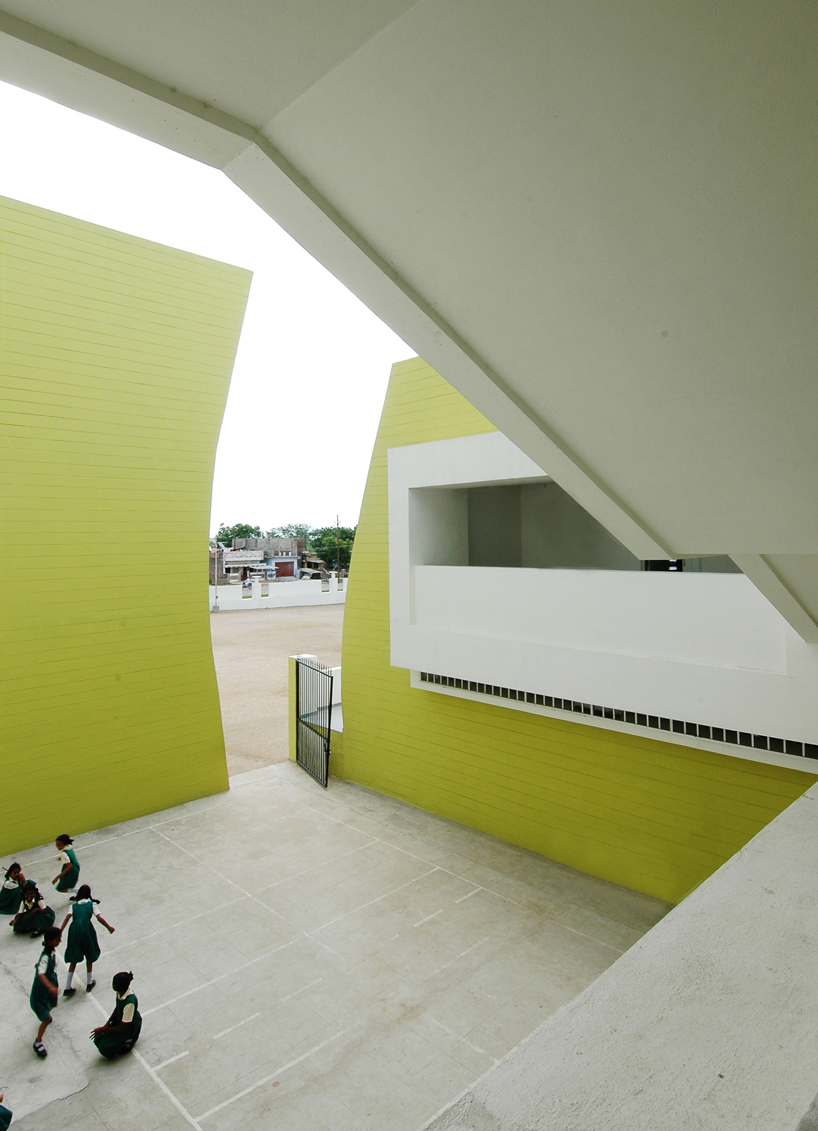 NUDES builds high school as monolithic mass 'punctuated' by voids in india