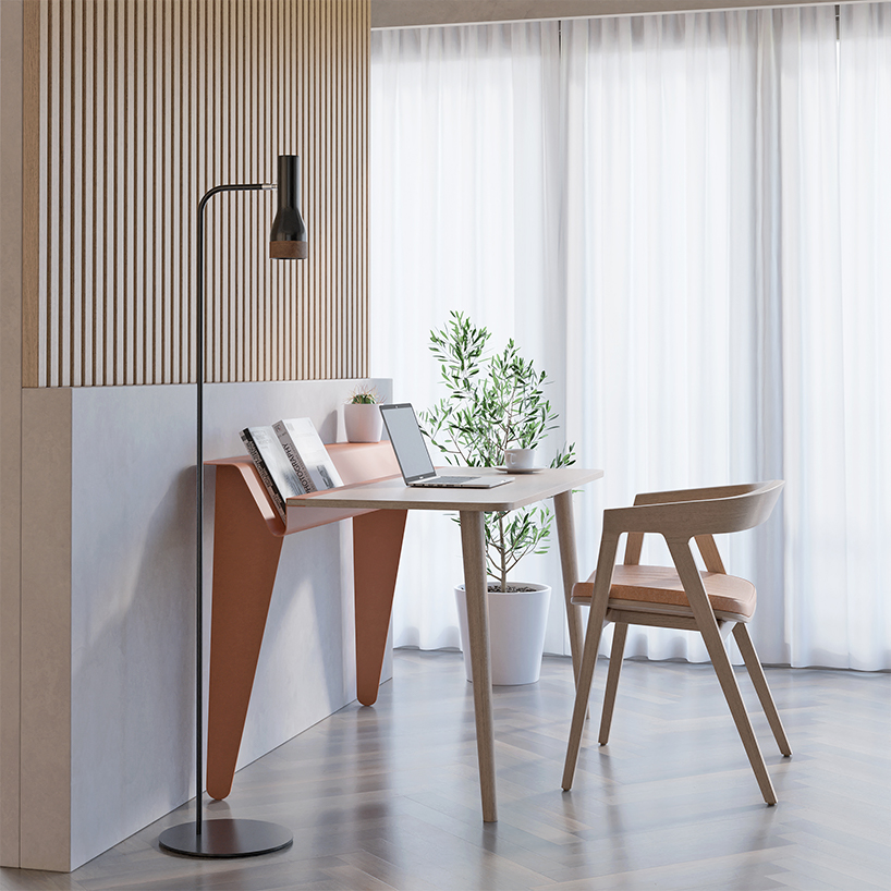 the piano desk features a metal stand that holds books like sheets of music designboom