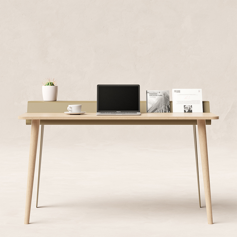 the piano desk features a metal stand that holds books like sheets of music designboom