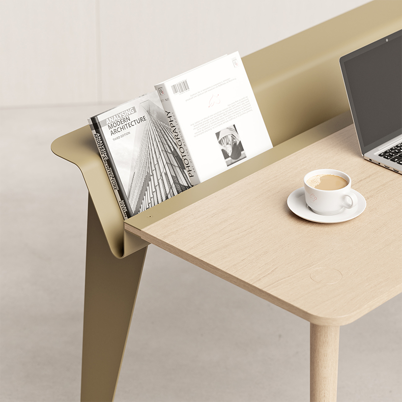 the piano desk features a metal stand that holds books like sheets of music designboom