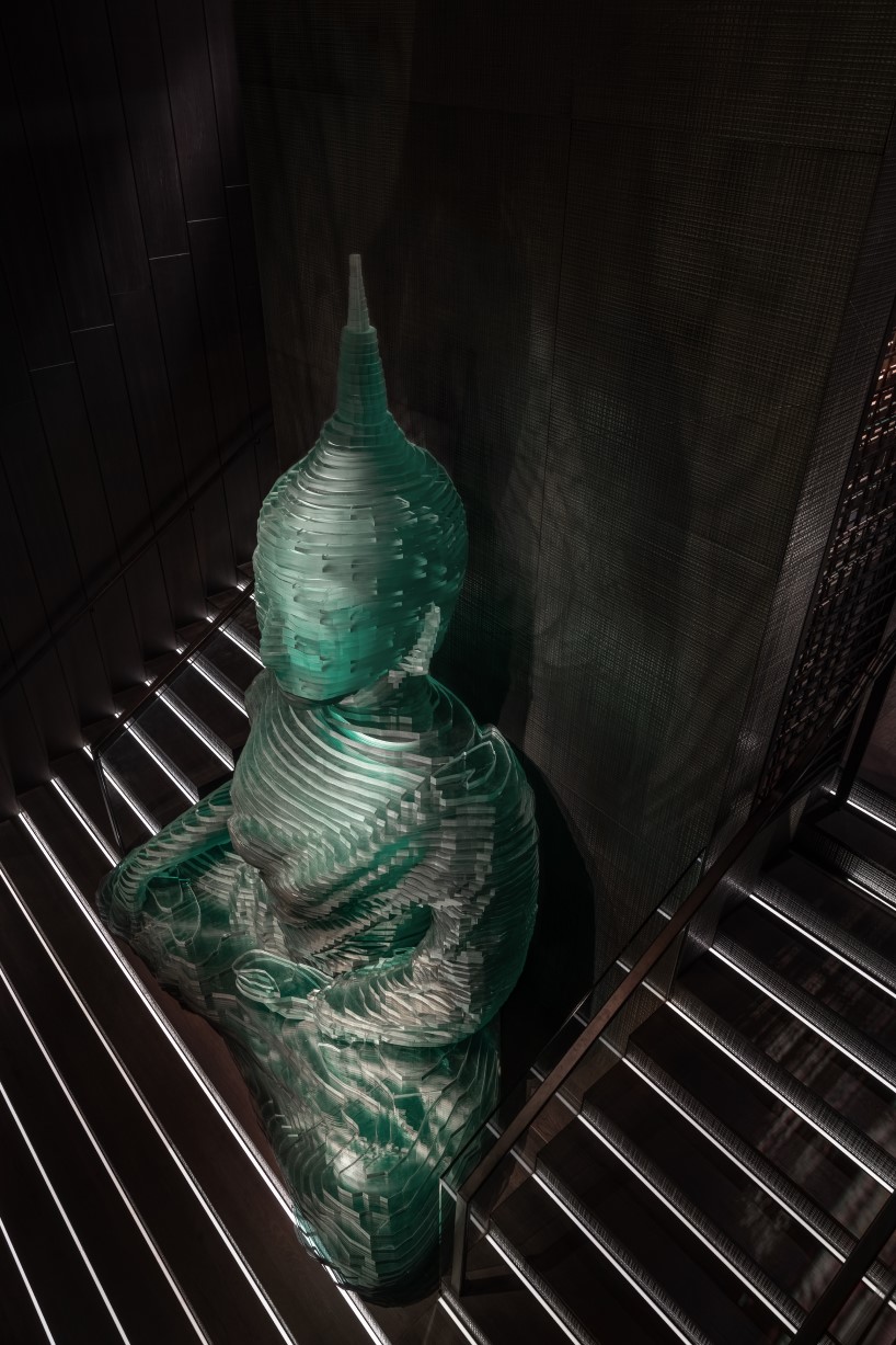 YOD group decorates new york restaurant interior with 4.5-meter-tall  glass-hewn buddha sculpture