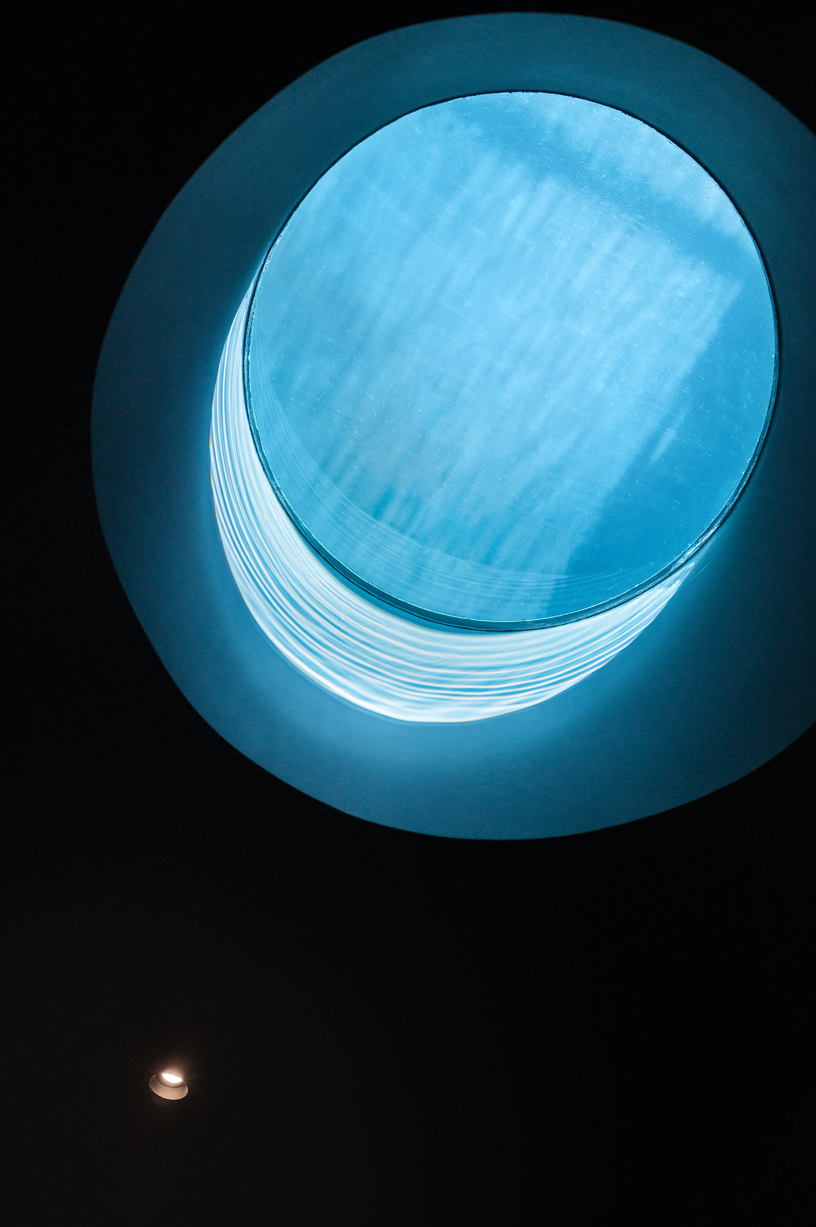 yod group embeds portholes looking into steel pool within hay boutique hotel's corridors