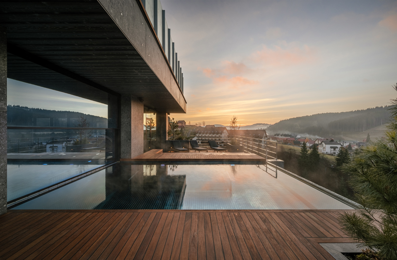 yod group embeds portholes looking into steel pool within hay boutique hotel's corridors
