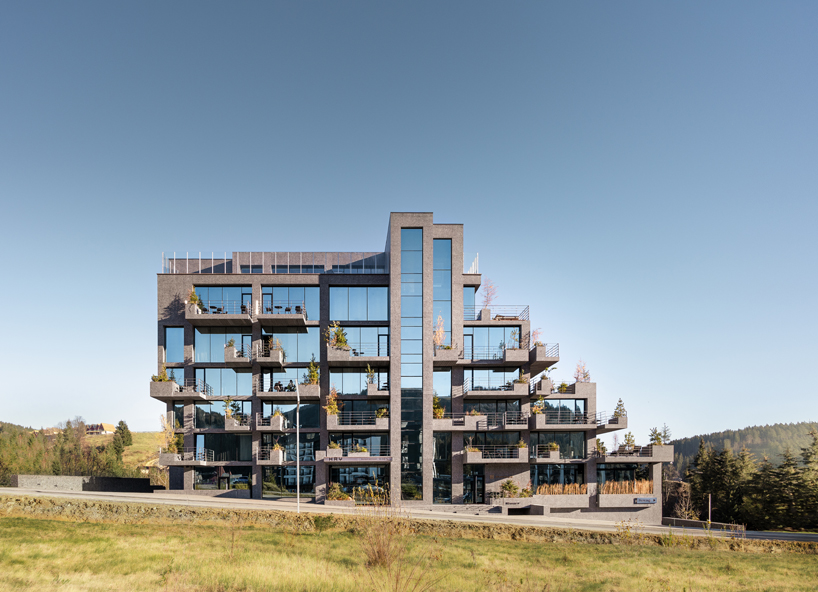yod group embeds portholes looking into steel pool within hay boutique hotel's corridors