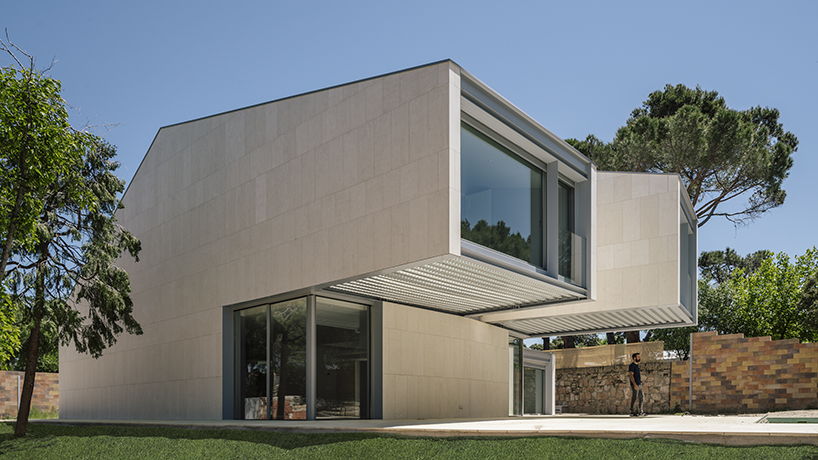 zooco estudio articulates casa M4 with three limestone volumes in madrid