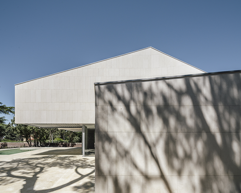 zooco estudio articulates casa M4 with three limestone volumes in madrid