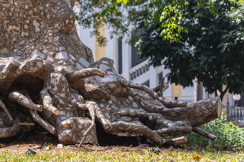 reflective steel skin clads sculpture emerged from fallen tree after typhoon in hanoi