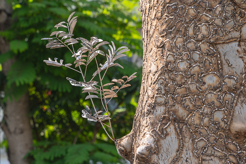 reflective steel skin clads sculpture emerged from fallen tree after typhoon in hanoi