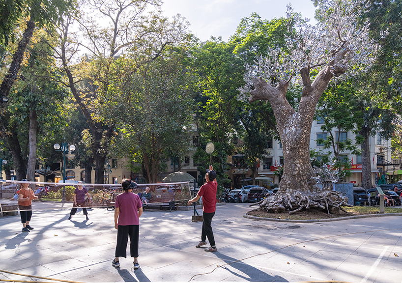reflective steel skin clads sculpture emerged from fallen tree after typhoon in hanoi