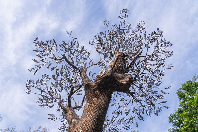 reflective steel skin clads sculpture emerged from fallen tree after typhoon in hanoi
