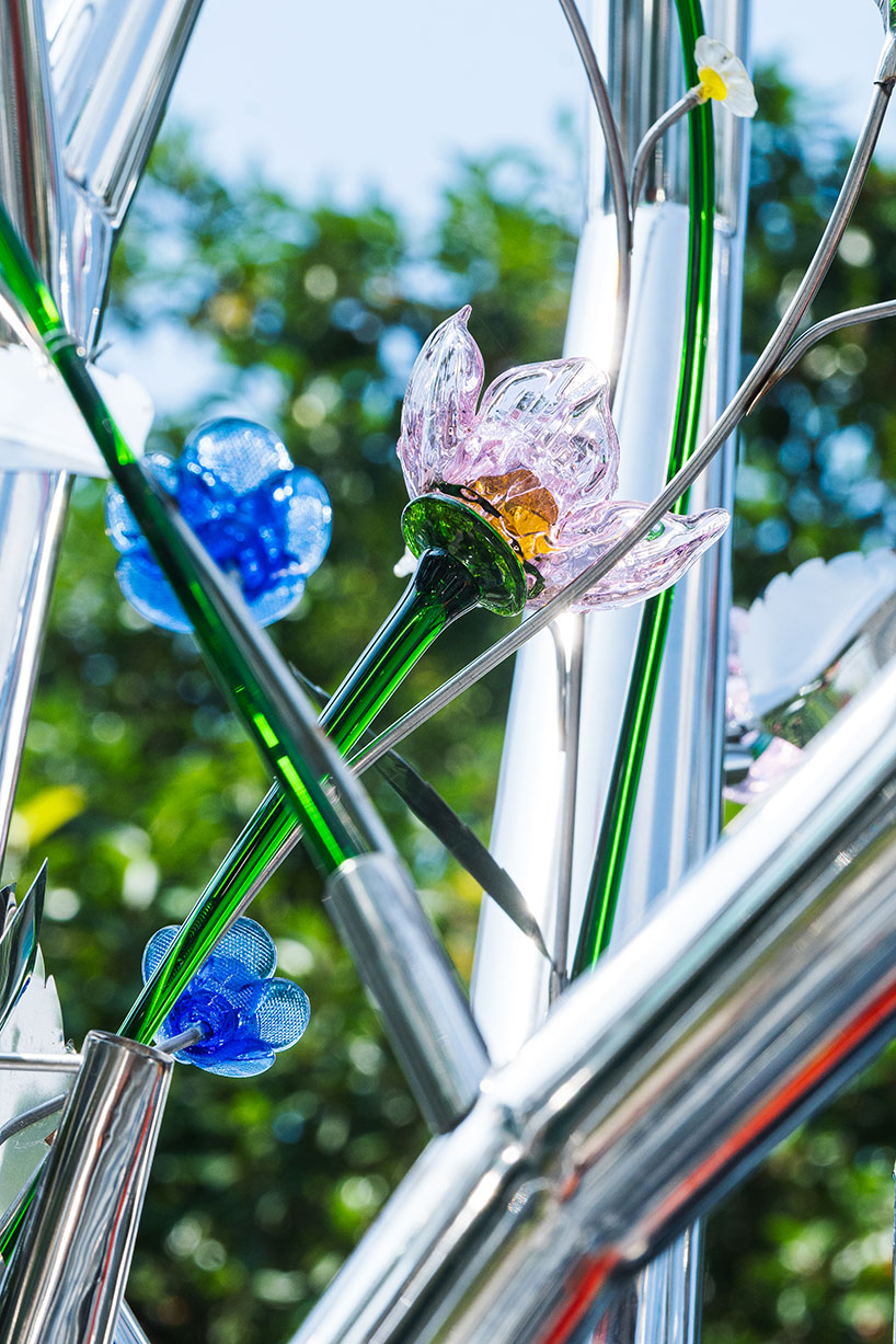 a circle of mirroring steel branches composes a luminous forest in hanoi's public realm