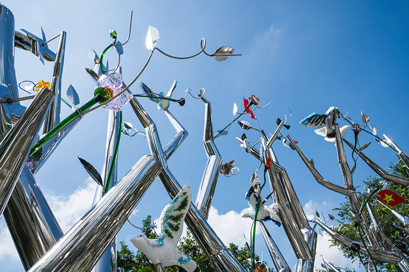 a circle of mirroring steel branches composes a luminous forest in hanoi's public realm