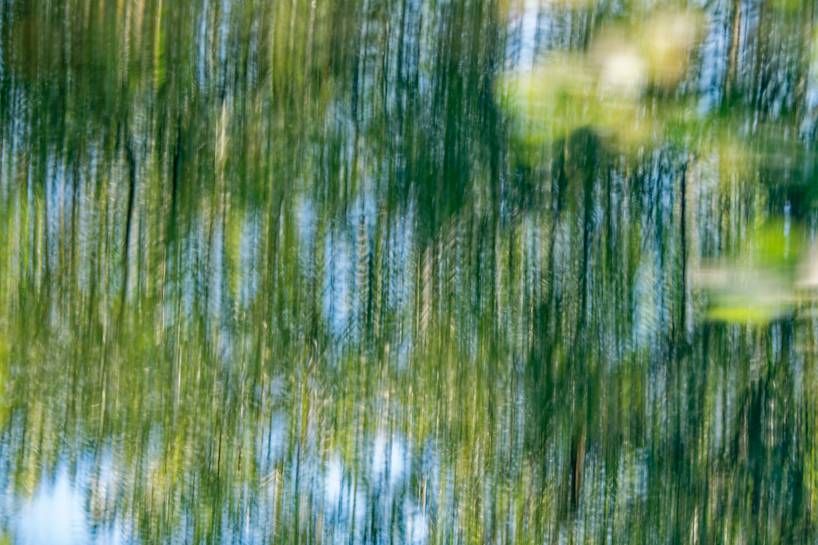 coral-toned timber and mirror canopy by GRRIZ transforms footbridge above river in france