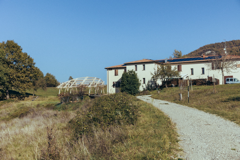 palcosole by grriz raises a half sun of timber above a historic park to gather community and light 8