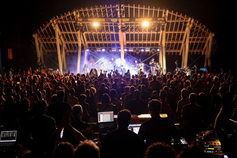 palcosole by grriz raises a half sun of timber above a historic park to gather community and light 9
