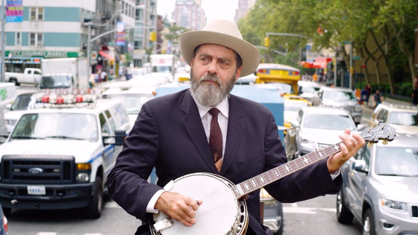 artist wayne white plays the banjo while strapped to a truck in NYC - 1