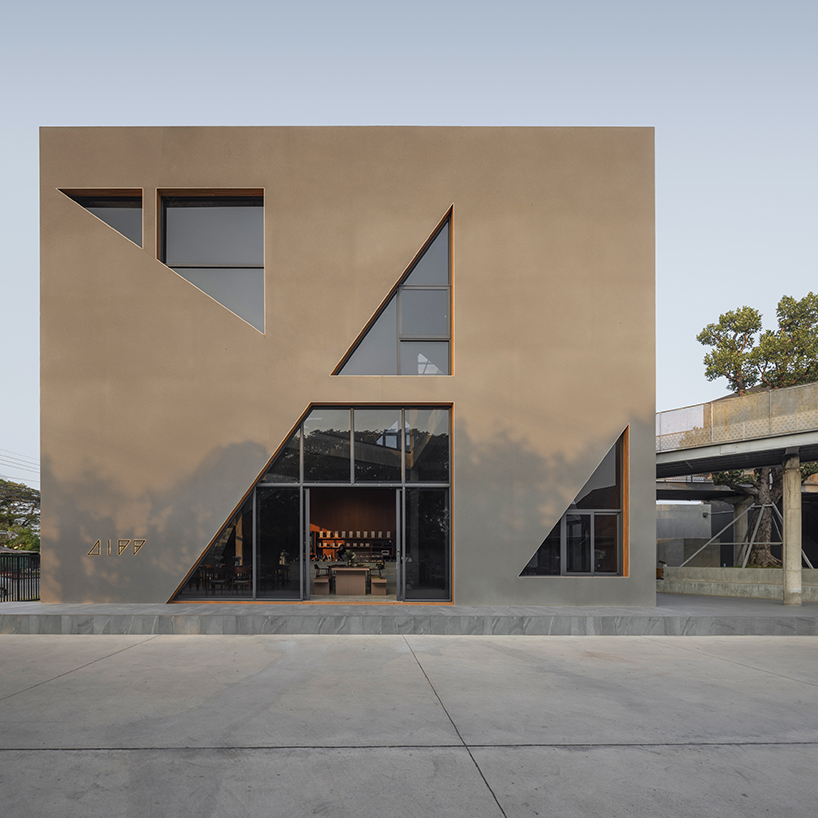 triangular skylights pierce café's concrete volumes by ASWA in thailand