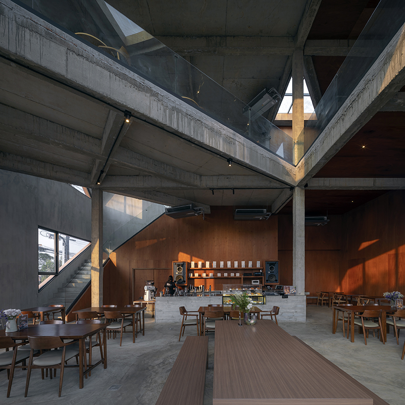 triangular skylights pierce café's concrete volumes by ASWA in thailand