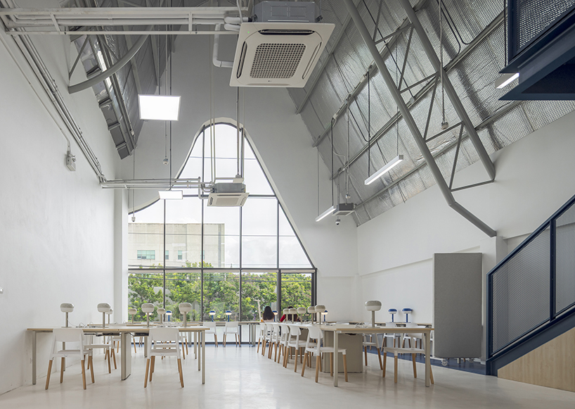 three asymmetrical curved gable roofs top ASWA’s community hub in thailand