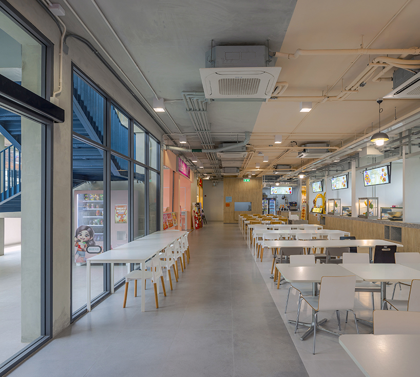 three asymmetrical curved gable roofs top ASWA’s community hub in thailand