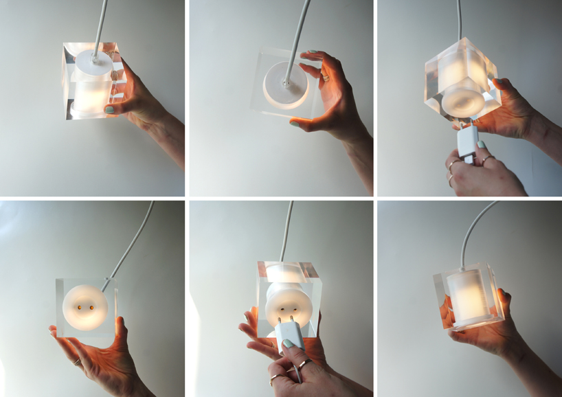 this suspending workspace lamp allows users to charge their devices simultaneously