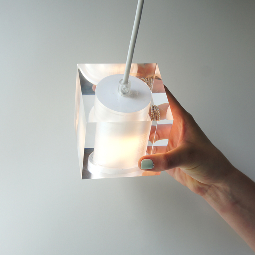 this suspending workspace lamp allows users to charge their devices simultaneously