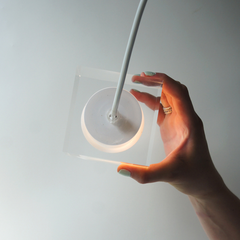 this suspending workspace lamp allows users to charge their devices simultaneously