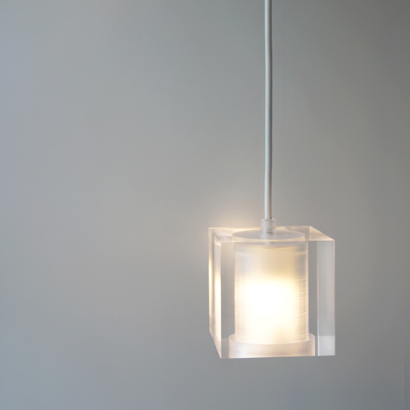 this suspending workspace lamp allows users to charge their devices simultaneously