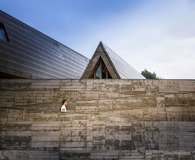 west-line studio's triangular-shaped cultural center in china pays homage to shui people