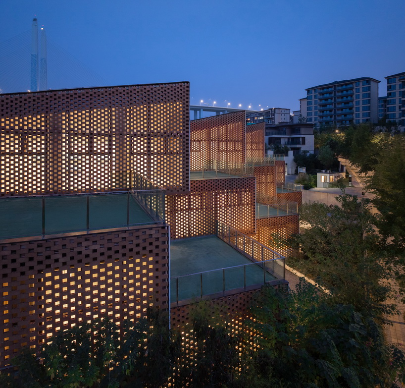 permeable terracotta brick screens wrap kindergarten's stacked volumes by NAN architects