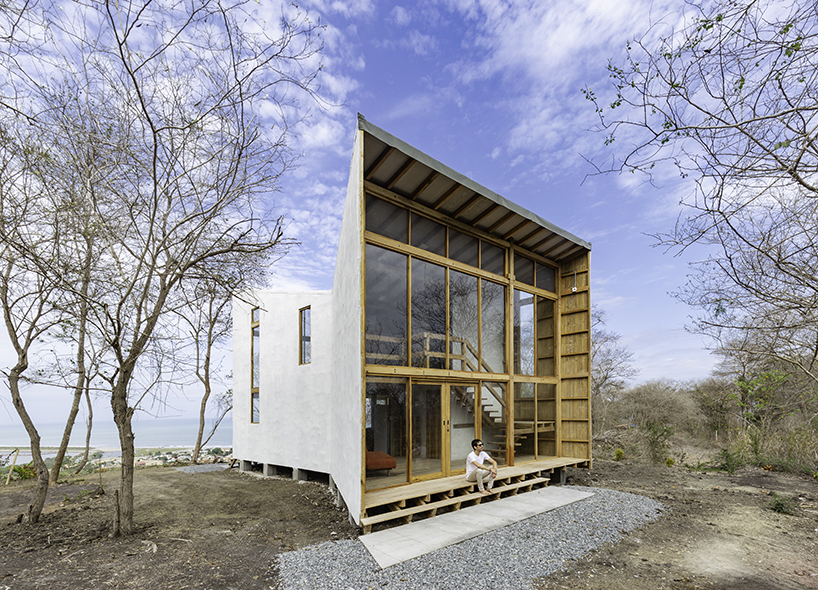 emilio lópez uses local wood to create double height spaces for house in ecuador