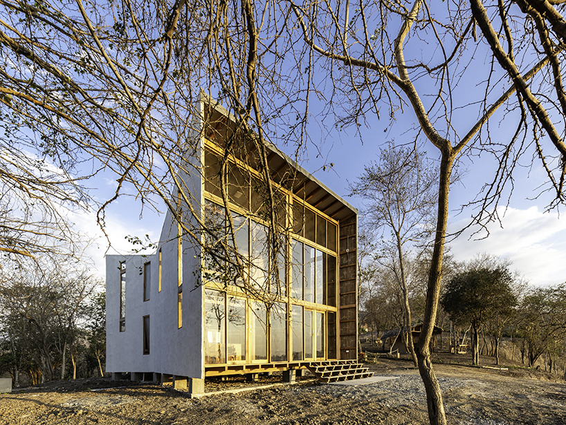 emilio lópez uses local wood to create double height spaces for house in ecuador