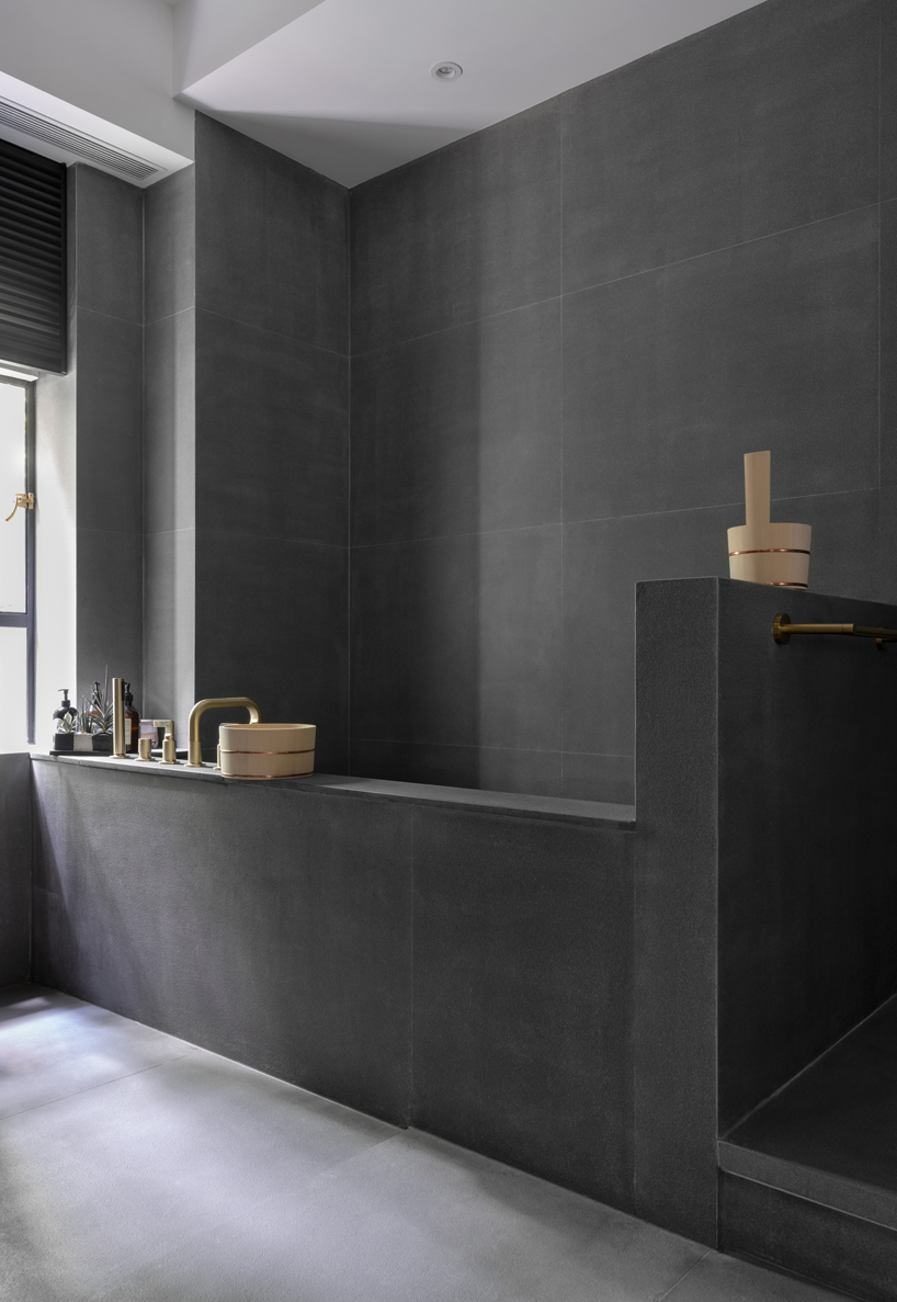 the children’s bathroom was designed with the traditional japanese bathroom in mind, with a deep soaking tub and a separate shower space to be used for relaxation and cleansing