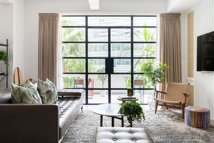 neutral colours and finishes allow the many pieces of greenery that decorate the space to shine a vibrant healthy green, blurring the line between the outdoors and the interior.