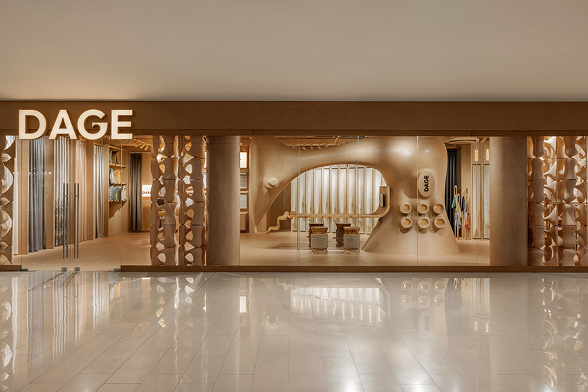 giant sewing machine sculpture takes center stage in dage curtain store by molos