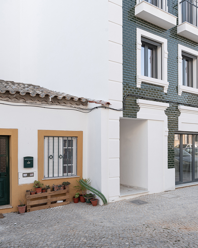 Um atelier corpo cola partes das fachadas de azulejos e esquadrias a um edifício em Portugal