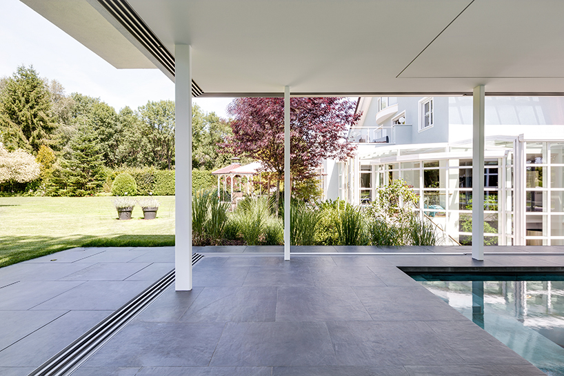 MEER architekten embeds private poolhouse as a glazed pavilion in ismaning, munich