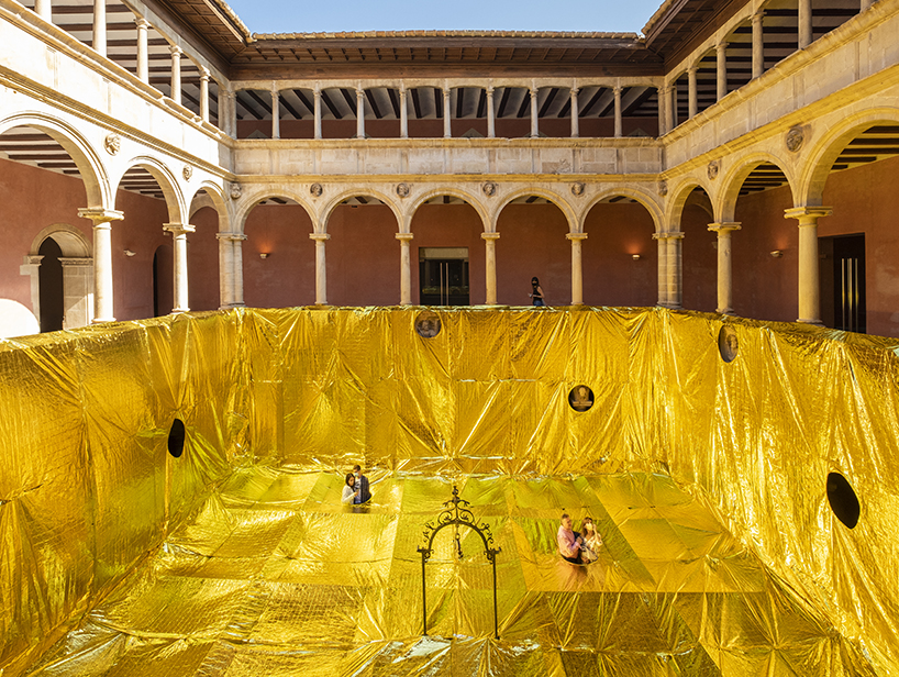 16th century patio covered with gold emergency blankets in spain 1