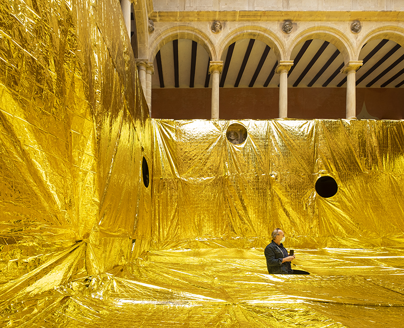 16th century patio covered with gold emergency blankets in spain 2