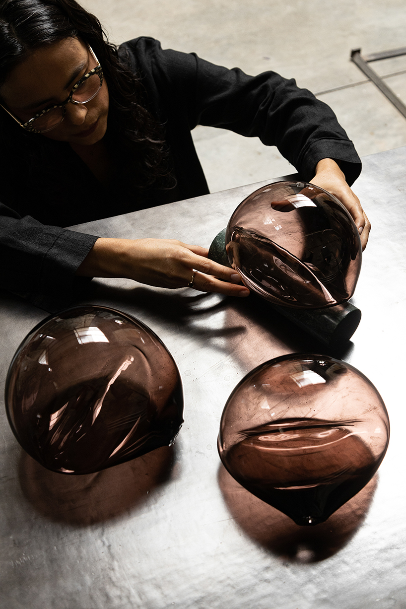 peca studio's talla lamp casts a light glow through a free-blown glass fixture