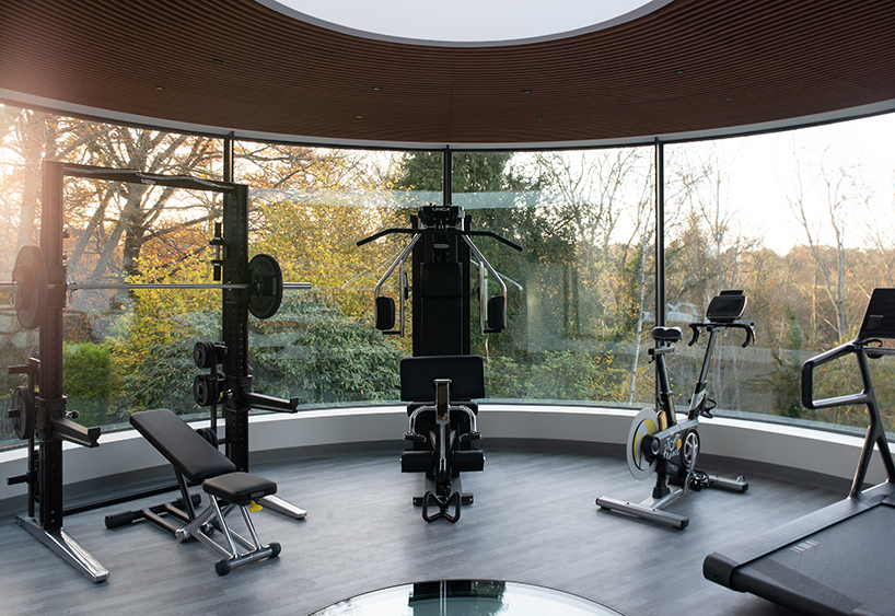 curved glass gym fit-out expands family residence in the uk