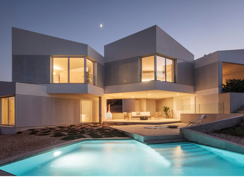 nomo studio lifts white polyhedral volumes above spanish landscape