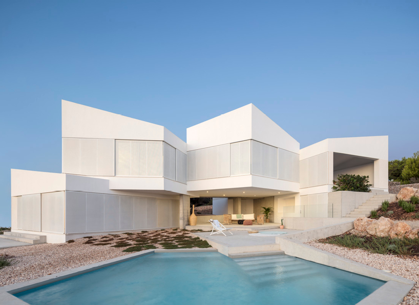 nomo studio lifts white polyhedral volumes above spanish landscape