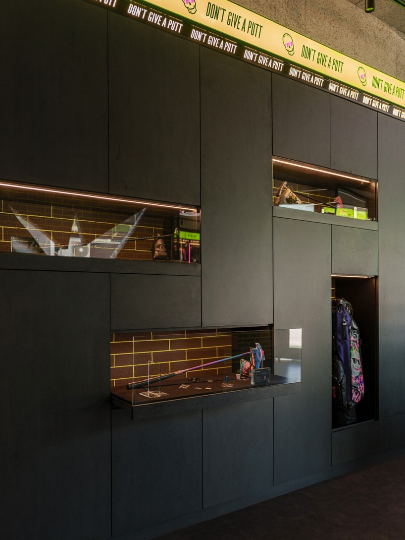 monochrome surfaces and neon accents outline swag golf bangkok flagship - 11