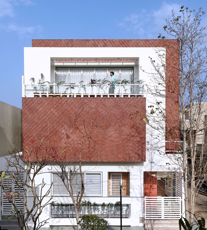 manoj patel reuses clay tiles in zig-zagging facade for residence in india