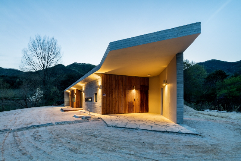 the apple farm house designed by 2m2 architects is inspired by its surrounding natural scenery