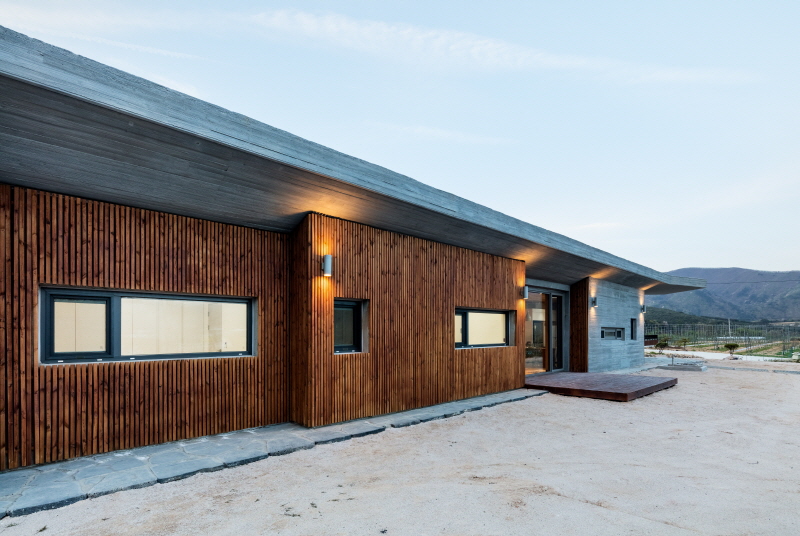 the apple farm house designed by 2m2 architects is inspired by its surrounding natural scenery