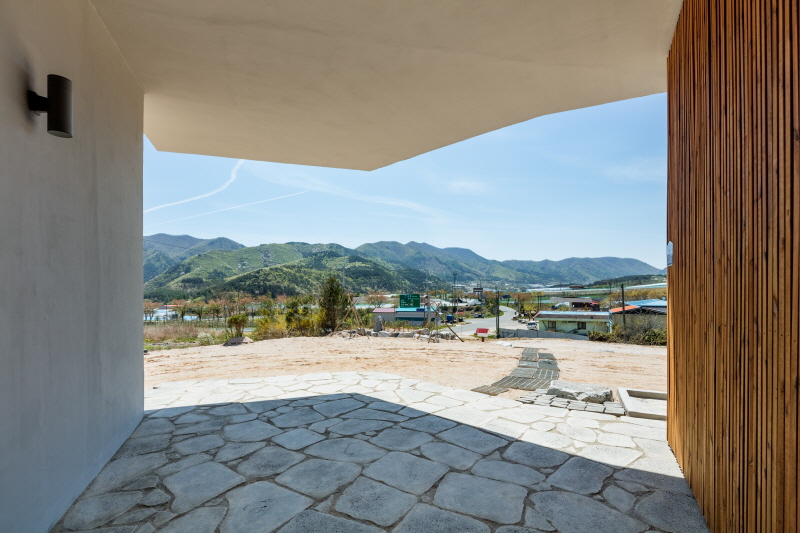 the apple farm house designed by 2m2 architects is inspired by its surrounding natural scenery