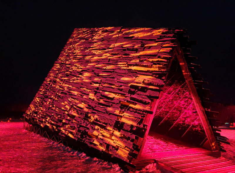 reflective red chamber emerges from prism mountain shelter’s charred wood shell
