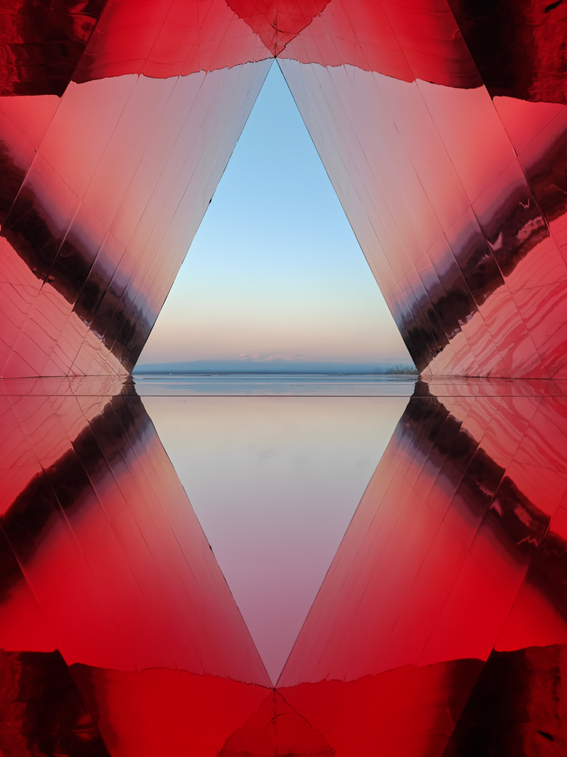 reflective red chamber emerges from prism mountain shelter’s charred wood shell